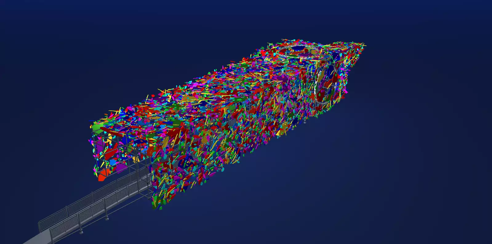 A screenshot showing a 3D model of Marta Minujín's Big Ben installation against a dark blue background. The sculpture of Big Ben is lying on it's side, and is constructed from scaffolding and clad with abstract, multi-coloured shapes. An entrance ramp on the left of the frame leads directly inside the sculpture.