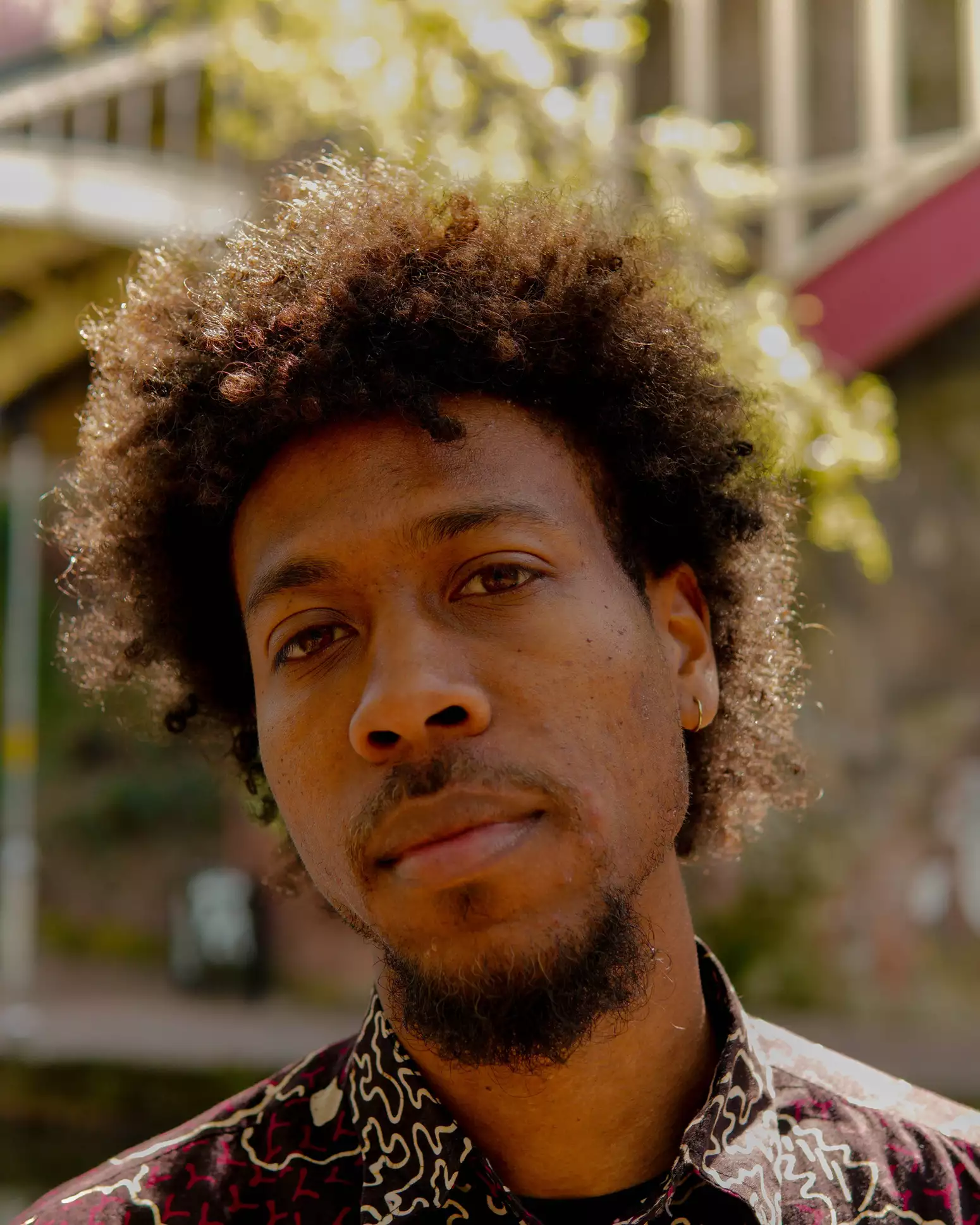 Close up of Jahday's face, looking directly into the camera. It's a sunny day