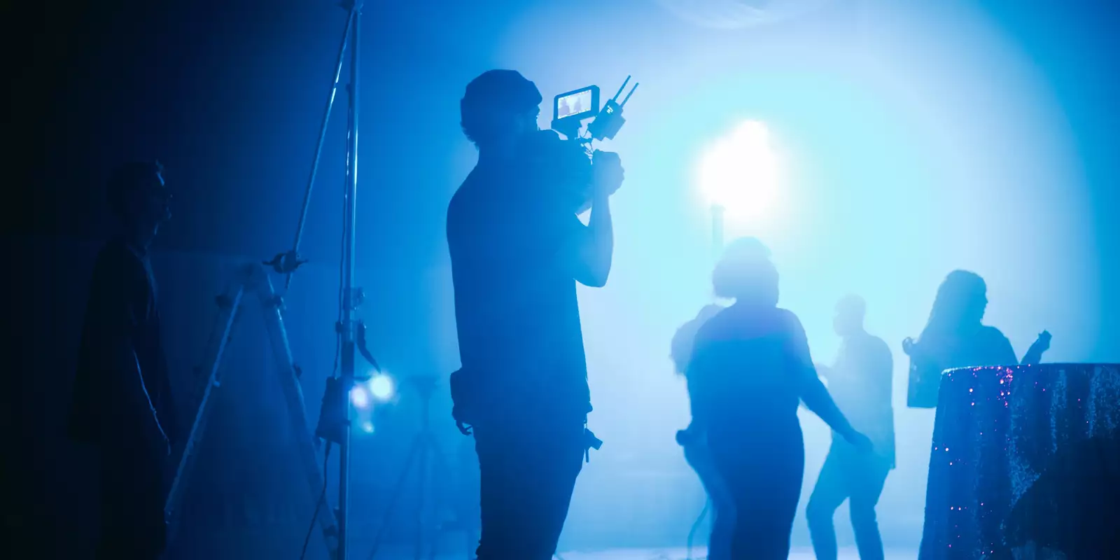 Young people using video cameras at a music venue