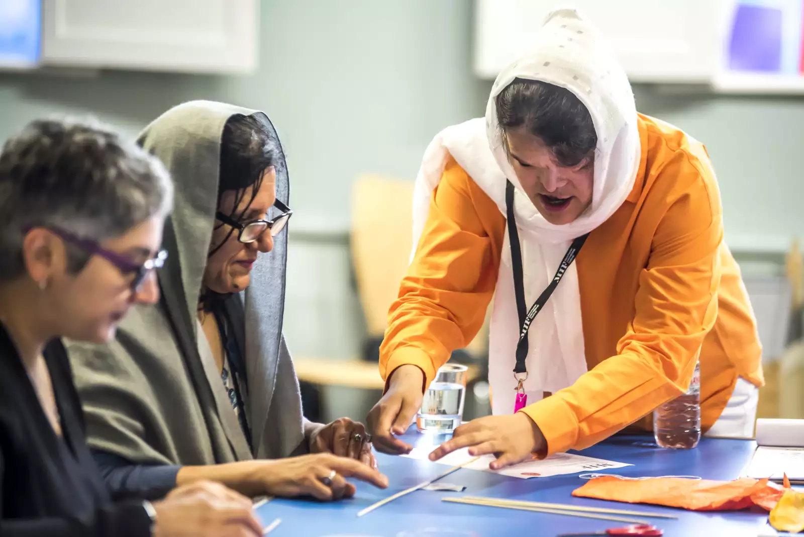 A woman delivering a kite making workshop